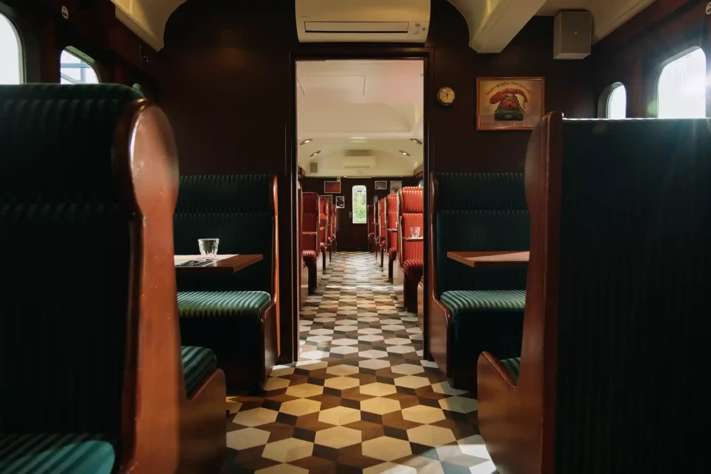 Salle intérieure du Restaurant Colmar inspirée d’un wagon de train.
